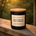 Back Porch in Early Morning soy candle in a matte black 10 oz jar with a red oak lid